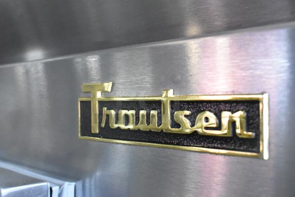 Traulsen RHT232WUT-FHS stainless steel logo detail on commercial cooler; durable, on casters, 115V, 1 phase.