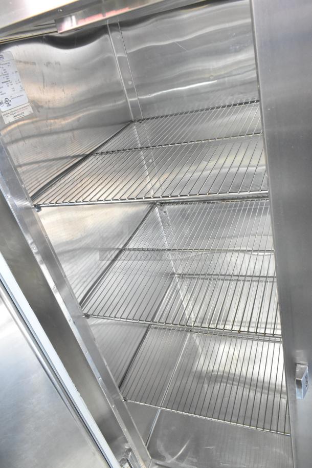 Traulsen RHT232WUT-FHS stainless steel commercial cooler interior with shelves, on casters. 2-door, 115V, 1 phase.