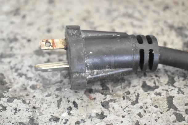Close-up of a damaged power plug from a 2020 Waring WPG300 Double Panini Press, highlighting wear and discoloration.