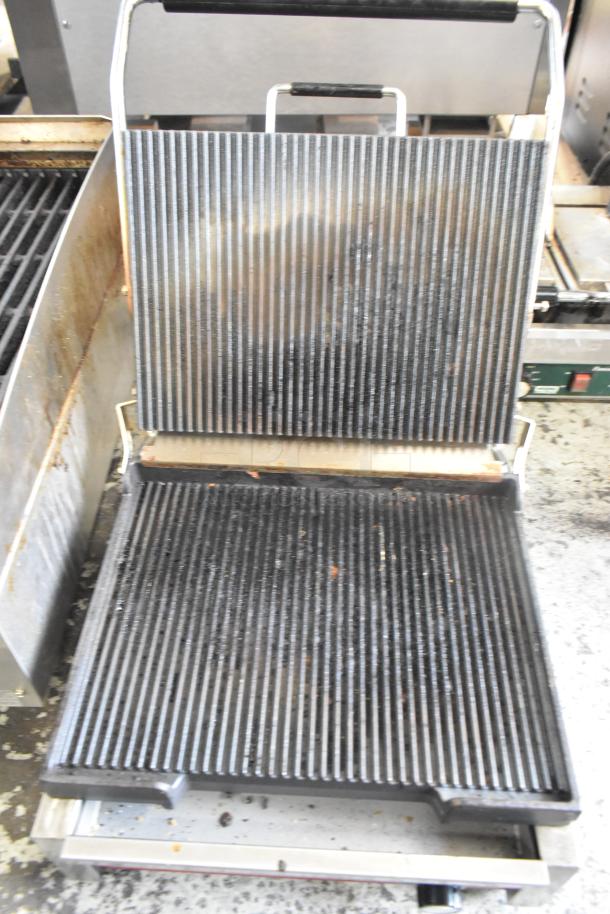 Winco EPG-1C stainless steel commercial countertop panini press, shown open with ribbed plates. 120V, 1 phase, used condition.