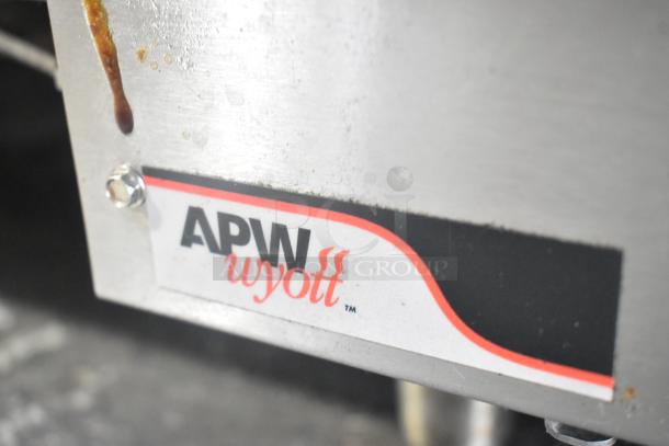 APW Wyott stainless steel commercial gas charbroiler, countertop model, close-up of brand label.