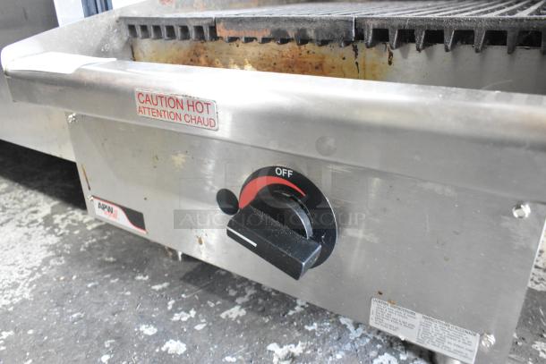 APW Wyott stainless steel countertop gas charbroiler grill, featuring a control knob and "Caution Hot" label. Used condition.