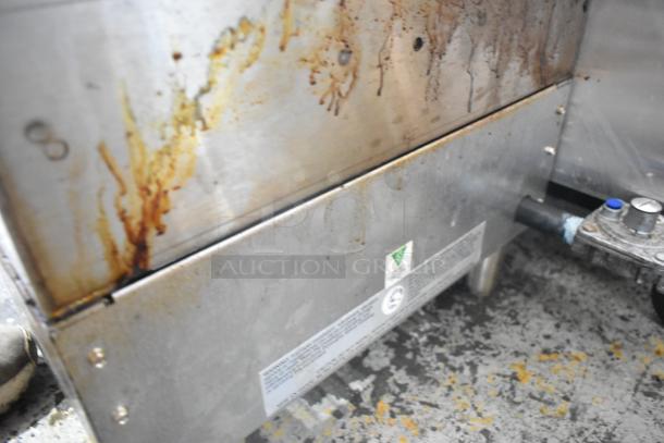 APW Wyott stainless steel commercial countertop charbroiler grill with visible grease stains and manufacturer's label.