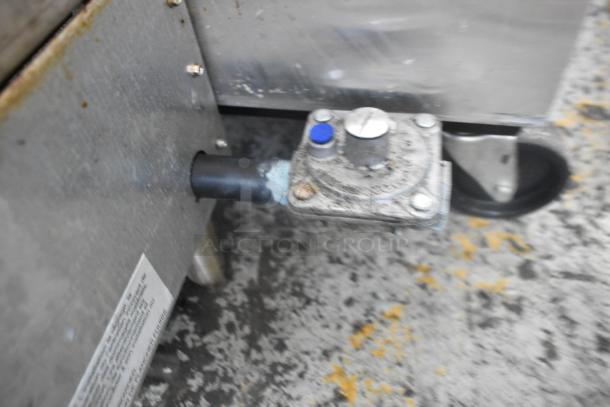 APW Wyott stainless steel commercial gas charbroiler grill, close-up of gas connection and control valve.