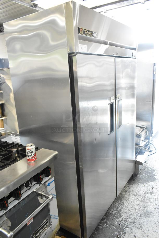 True TM-52F stainless steel commercial 2-door reach-in freezer. 115V, 1 phase. Clean exterior, visible True branding.