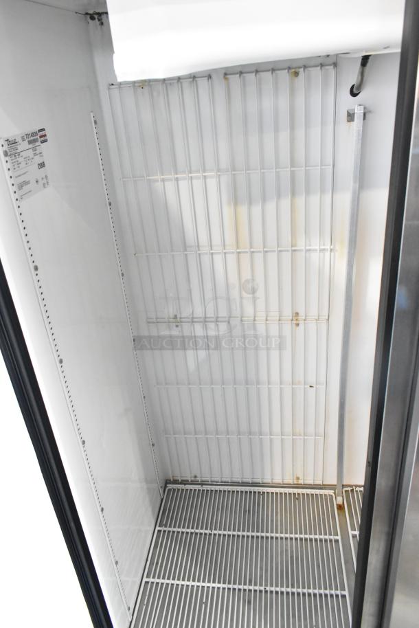 True TM-52F Stainless Steel Commercial 2 Door Reach In Freezer, interior view, shelves, 115 Volts, 1 Phase, model label.