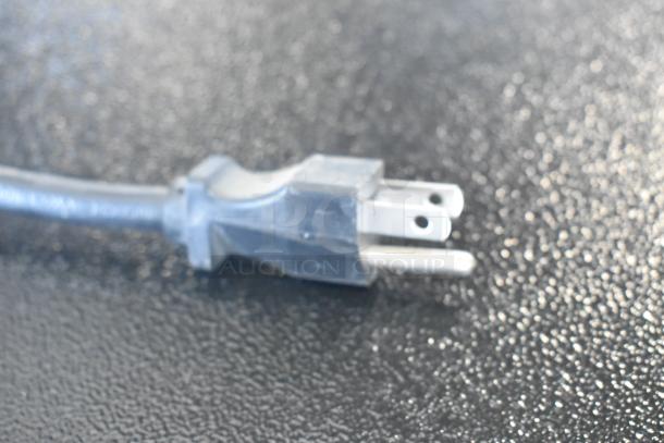 Close-up of a power plug, likely for the Cecilware GB5MFITLD Beverage Dispenser, 120V, 1 Phase.