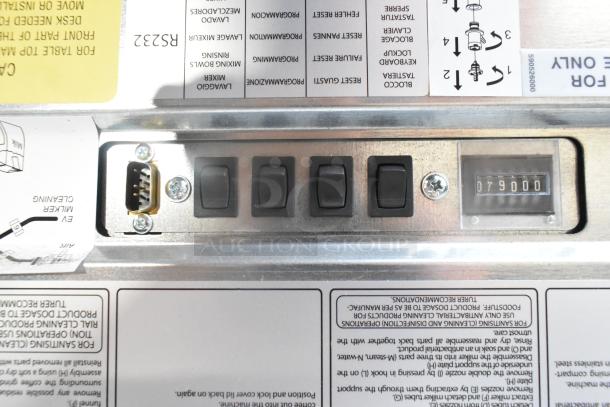 Close-up of Necta Kolbalto Espresso Machine control panel showcasing switches, labels with instructions, and a counter reading "079000".