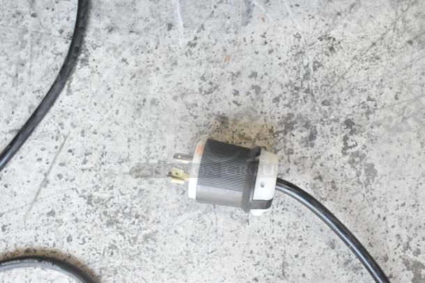 Necta Kolbalto Espresso Machine power plug and cable on a concrete floor, indicating 208/250 Volts, 1 Phase setup.
