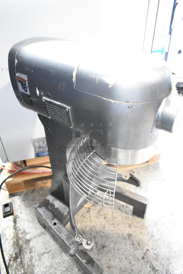 Avantco MX20 commercial 20-quart dough mixer with bowl guard. 120 volts, 1 phase. Visible wear, metal exterior, sturdy base.