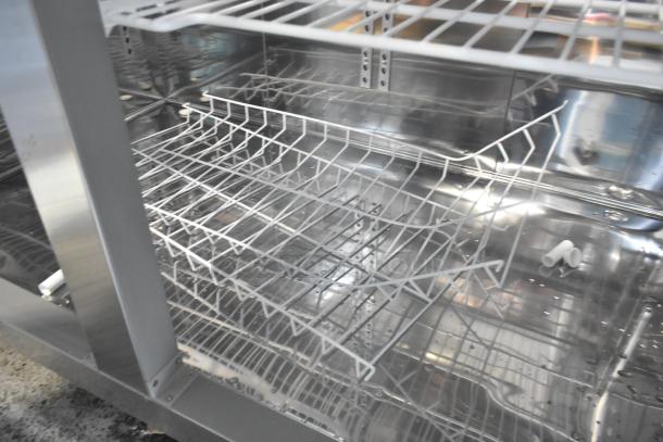 2023 Lassele LS-1045F stainless steel commercial freezer with 4 half-size doors, poly-coated racks, on casters; untested, cut power cord.