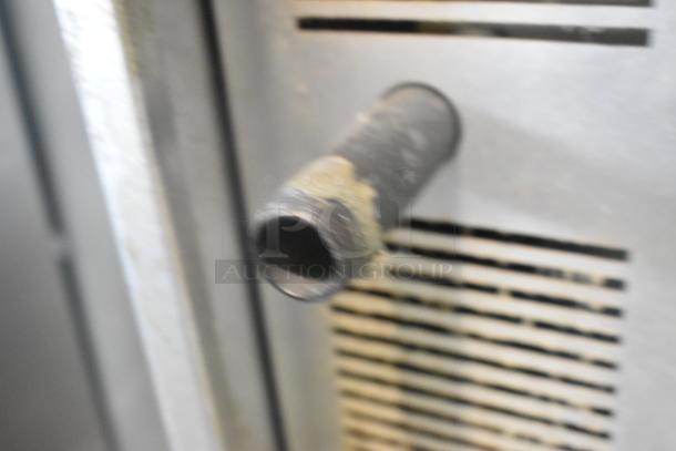 Close-up of a stainless steel Cook Rite ATCO-513NB convection oven component, showing wear. Features vent and pipe.