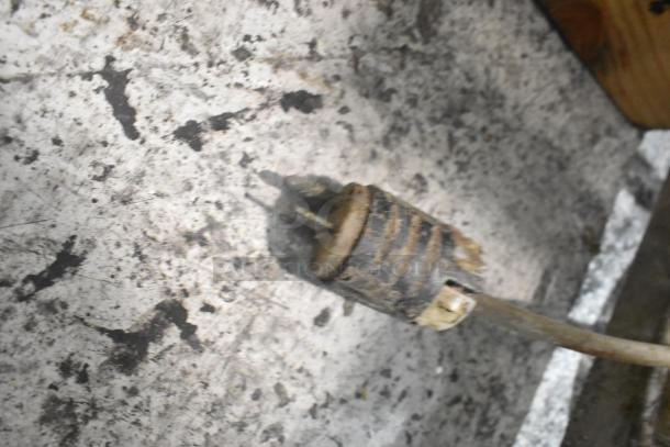 Old, worn power plug on a marbled surface. Likely part of the Metal Commercial Floor Style Marinating Station.