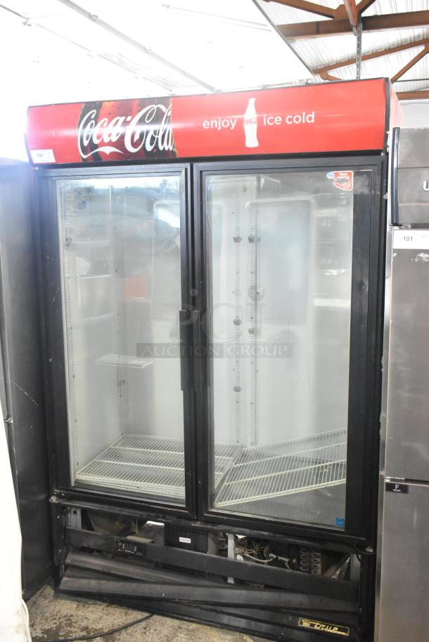 True GDM-49EM commercial cooler, two glass doors, poly-coated racks, "Coca-Cola" branding. 115 volts, 1 phase.