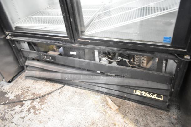 True GDM-49EM commercial cooler, two glass doors, poly coated racks, 115V, visible wear, model labeling on the front.