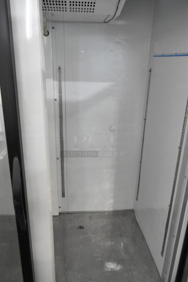 Maxx Cold MXM2-48R Commercial Cooler interior, empty, metal shelves and cooling unit visible, in good condition.