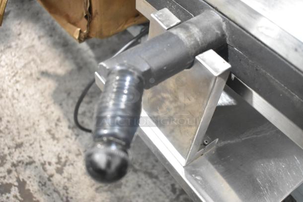 Stainless steel commercial countertop waffle maker handle, sturdy build, showcasing industrial finish.