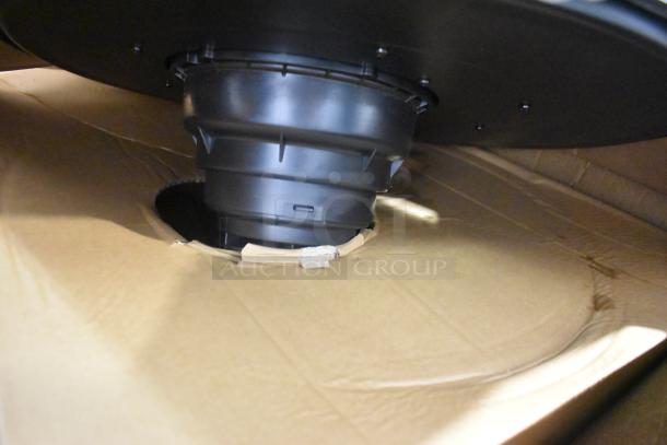 Dayton 61HV93 Drum Head, black, 120 Volts, 1 Phase, shown partially inside cardboard packaging.