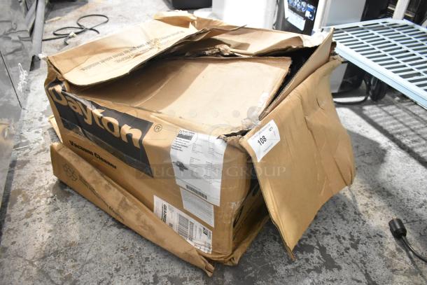 Dayton 61HV93 Drum Head in damaged box, 120 volts, 1 phase. Visible labels indicate model and specifications.