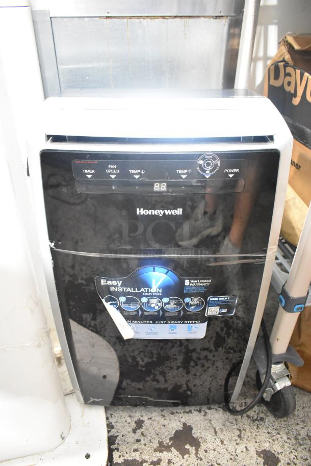 Honeywell MN10CES portable air conditioner, black, visible controls, 115 volts, 1 phase, easy installation label, good condition.