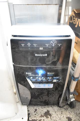 Honeywell MN10CES portable air conditioner, black, visible controls, 115 volts, 1 phase, easy installation label, good condition.