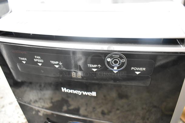 Honeywell MN10CES portable air conditioner, black with control panel. 115 volts, 1 phase. Visible buttons for timer, fan speed, and temp.