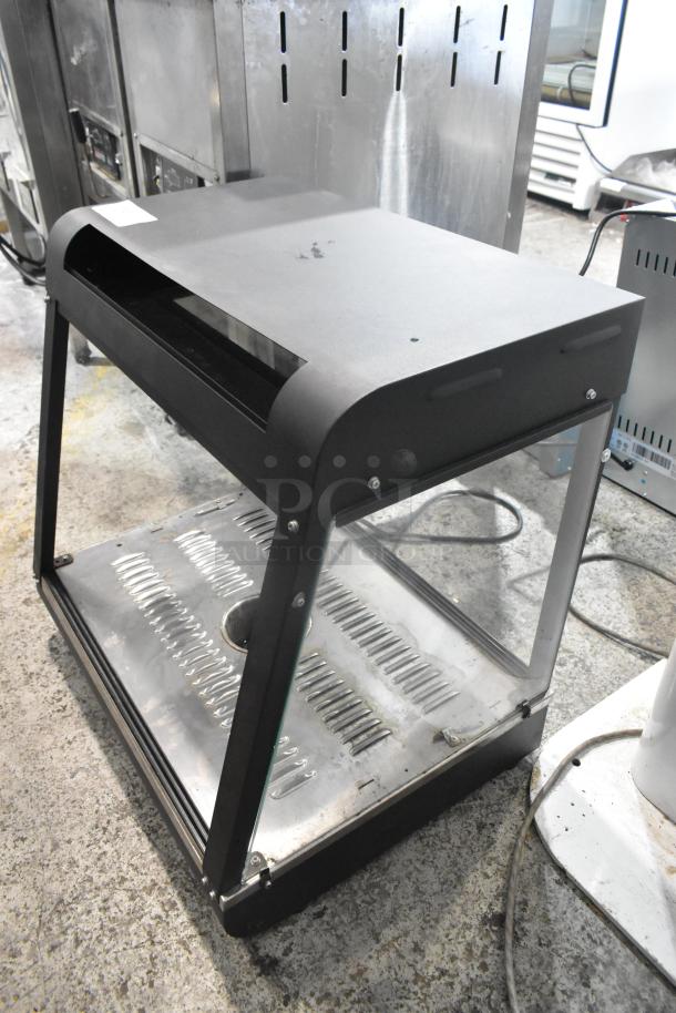 2022 metal commercial countertop heated display case, 110 volts, 1 phase, used condition, glass front, black metal frame.