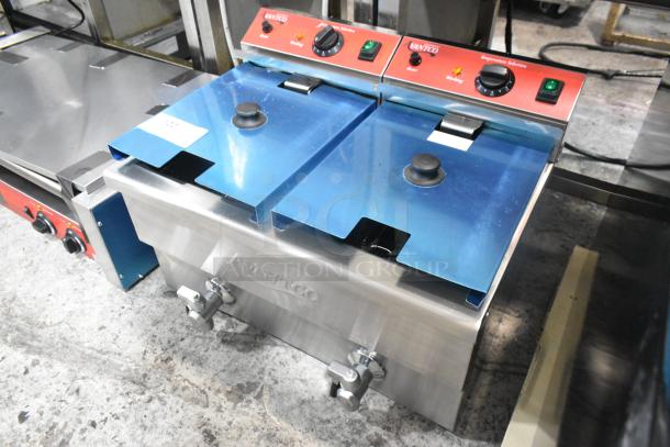 Brand new Avantco 177F202 stainless steel dual tank electric fryer, 30 lb. capacity, with two metal baskets and lids.