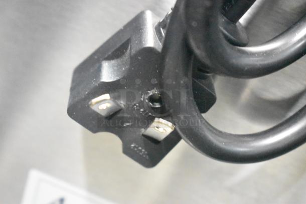 Close-up of a power plug for the Avantco 177F202 stainless steel 30 lb. electric fryer, showcasing its 208-240 volt capacity.