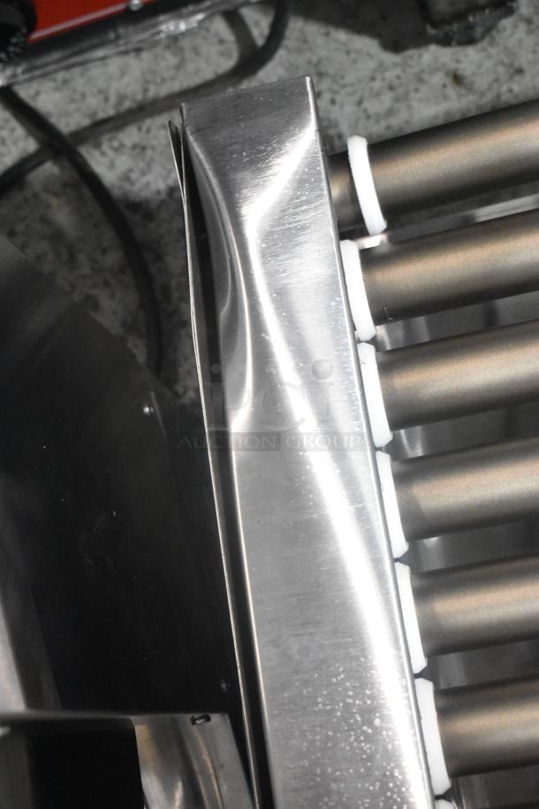 Brand new Avantco 177RG1850NS stainless steel hot dog roller grill with 11 non-stick rollers, slight dent visible.