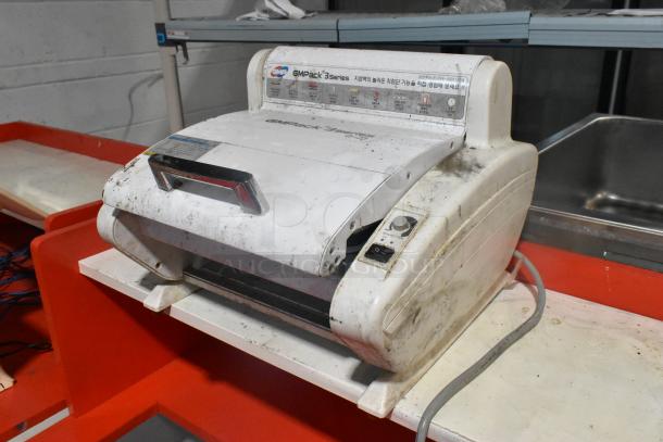 GMPack 3 Series Q-23 unit, white with red accents, shown in used condition with visible dirt and markings on the surface.