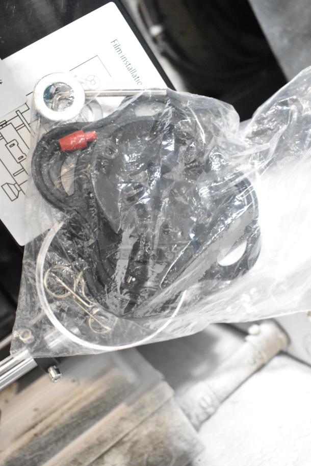 Brand new Galaxy 177CSFA cup sealing machine parts in clear packaging with installation guide visible underneath.