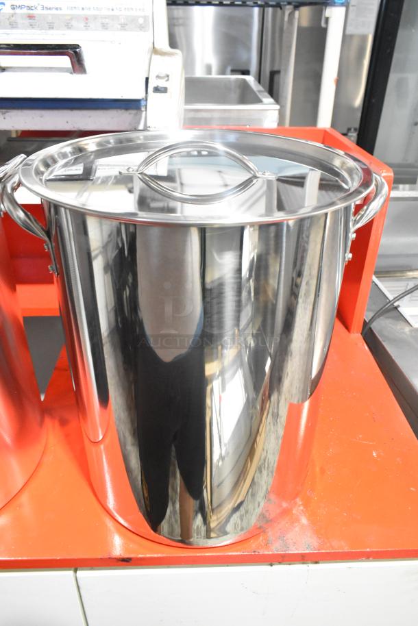Stainless steel deep fat fryer stock pot, brand new with slight scratches and dents, includes lid and side handles.