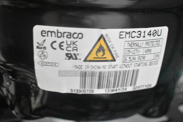 Embraco EMC3140U compressor label, showing markings for electrical specifications, safety warnings, and usage information.