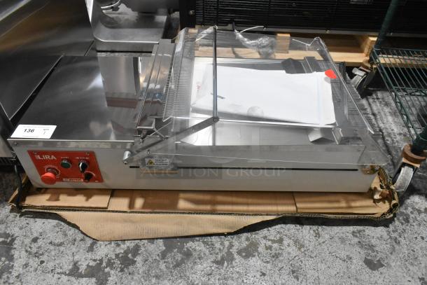Brand new Pavoni LIRA/E110V semi-automatic dessert slicer, 110V, 1 phase, slight scratches and dents, with control panel.
