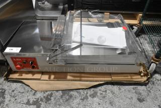 Brand new Pavoni LIRA/E110V semi-automatic dessert slicer, 110V, 1 phase, slight scratches and dents, with control panel.