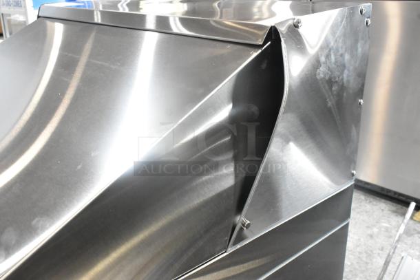 Brand new Avantco 178ZPT27MHC stainless steel refrigerated sandwich prep table, showing a scratch and dent detail.