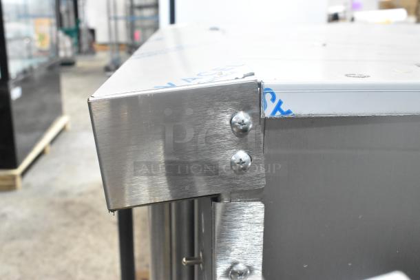 Close-up of a corner of the brand new Wolf WC4GD-21D3 stainless steel convection oven, showing minor scratches on the surface.