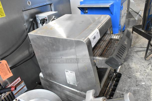 Star Holman QCS-1-350 stainless steel commercial conveyor toaster oven, shows wear, 120 volts, labeled, auction tag visible.
