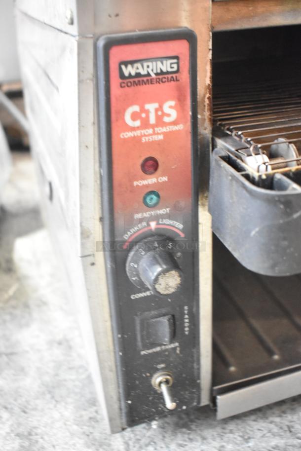 Waring CTS1000 stainless steel commercial conveyor toaster oven, 120 volts, with power and ready lights, knob settings visible.