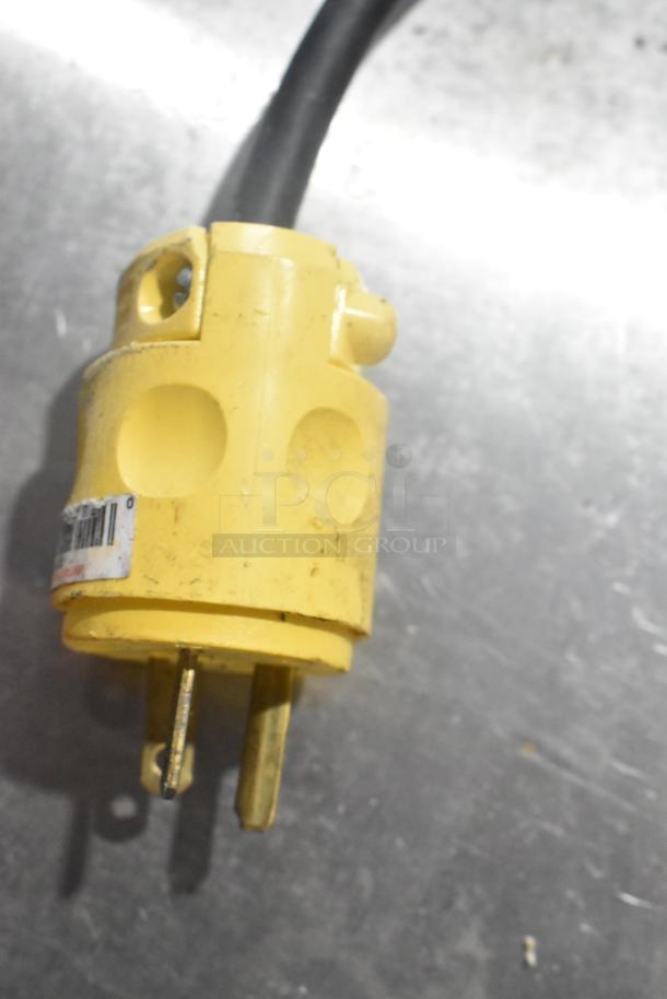 Yellow plug of Waring CTS1000 Conveyor Toaster Oven, 120V, shown on a metallic surface. Plug appears used.