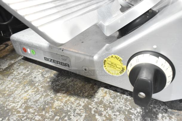 Bizerba GSP metal commercial meat slicer, 115 volts, 1 phase, visible control dial, label advises to set thickness knob to zero.