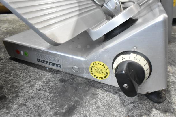 Bizerba SE 12 US commercial meat slicer, metal, 115V, 1 phase, countertop model in used condition with control knobs.