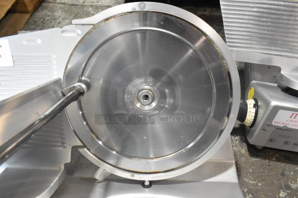 Bizerba SE 12 US metal commercial meat slicer, 115 volts, 1 phase, sleek stainless steel finish, visible control dial.
