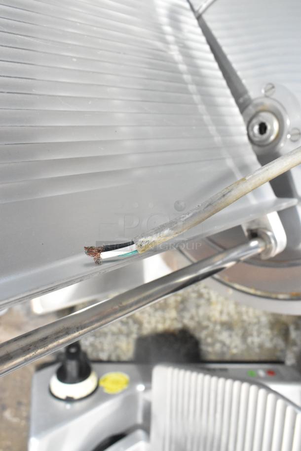 Bizerba SE 12 US commercial countertop meat slicer, 115 volts, 1 phase. Metal construction, visible wiring issue.