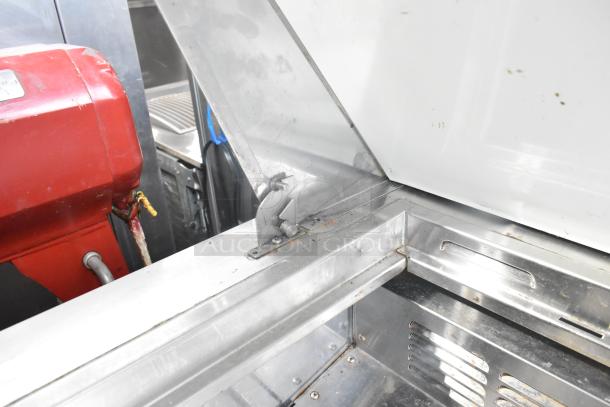 Everest EPBR2 stainless steel salad prep table top detail, showing interior lining and cabinet hinges. Signs of minor wear visible.