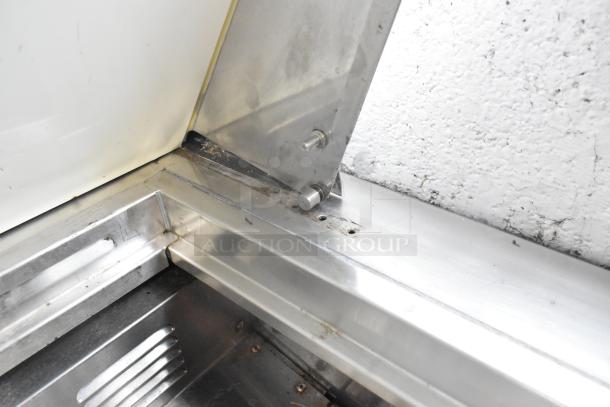 Everest EPBR2 stainless steel sandwich salad prep table corner detail showing wear and commercial-grade construction.