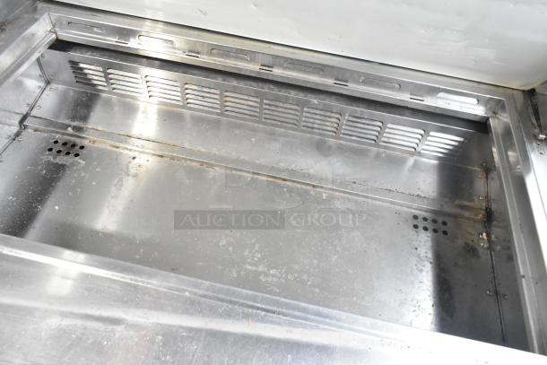 Everest EPBR2 stainless steel sandwich salad prep table, showing interior condition, mega top, and commercial casters.