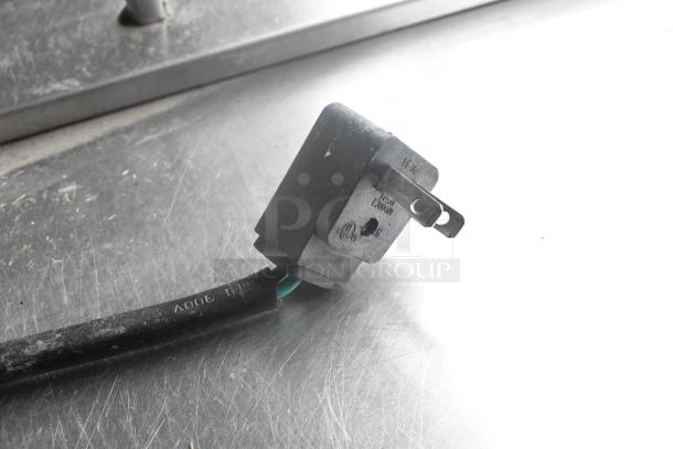 Stainless steel power plug for Everest EPBR2 prep table, showing 115V label, on a metallic surface.