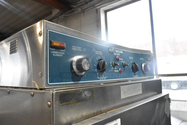 Alto Shaam 1000-TH-I stainless steel cook and hold oven on casters, 208-240V, 1 phase, featuring control dials and indicators.